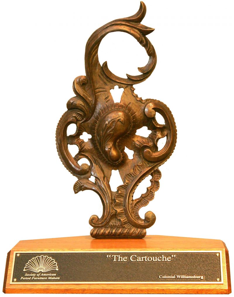 The Cartouche — bronze cast on mahogany base, with brass plaque